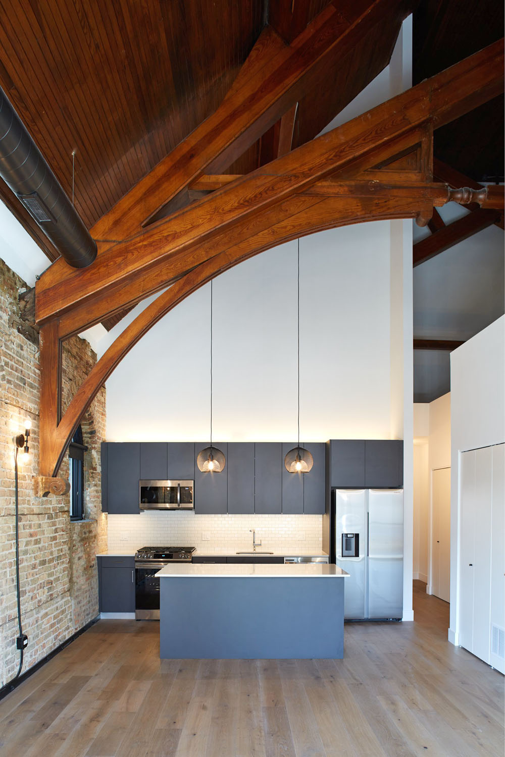 Modern Loft Kitchen with Rustic Wooden Trusses