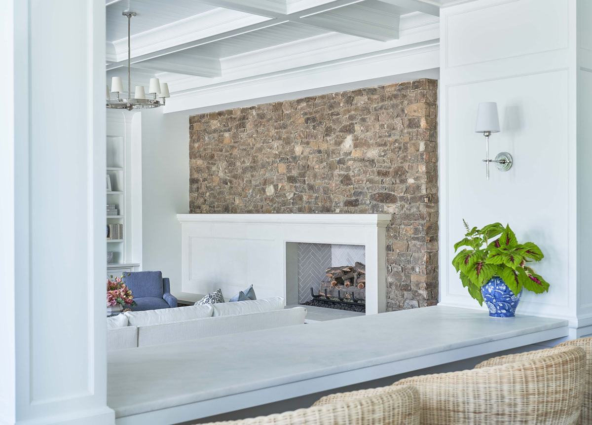 Fireplace with White Paneling and Stone Wall