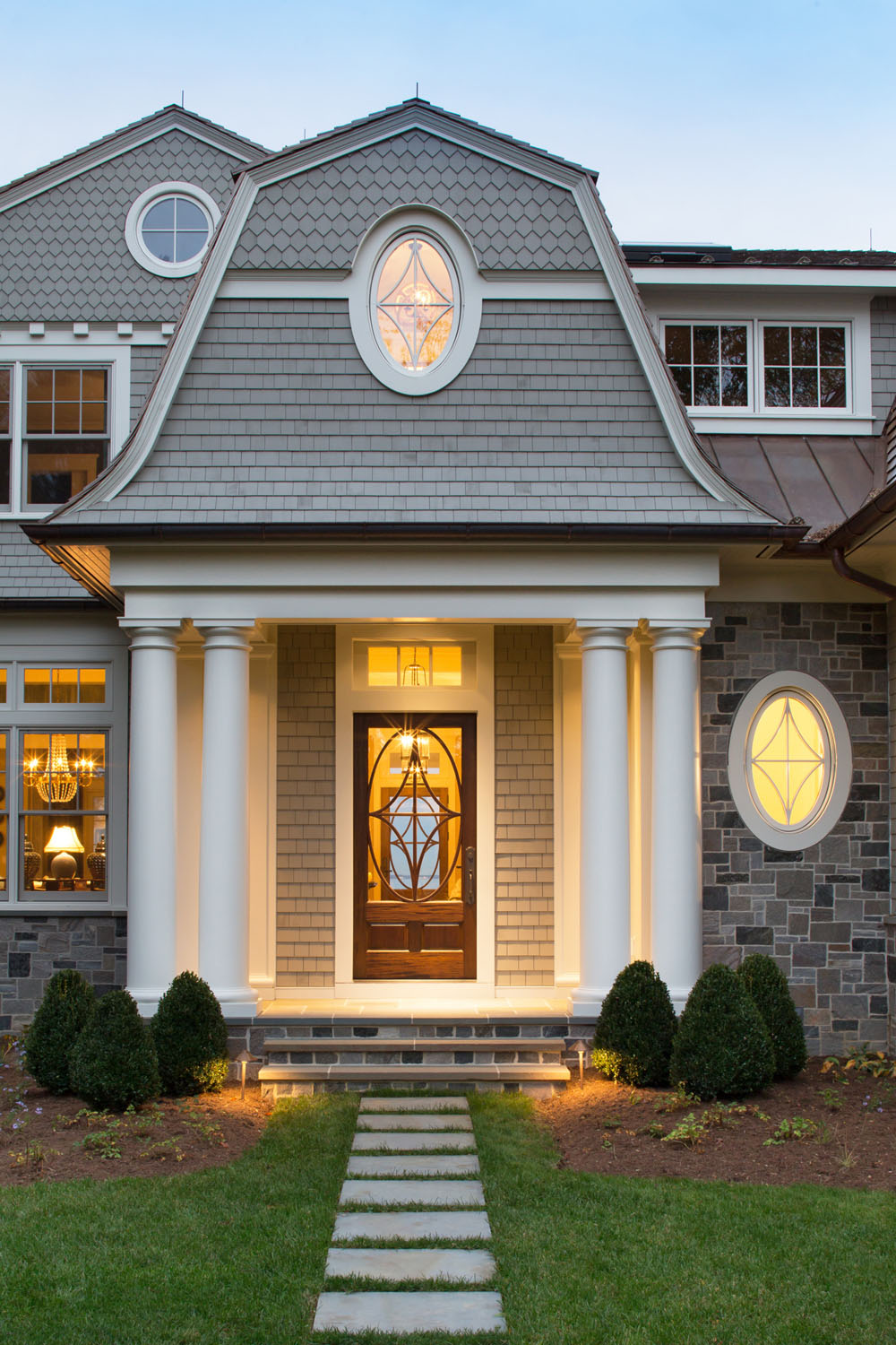 Front Entry Portico with Gambrel Roof and Oval Windows