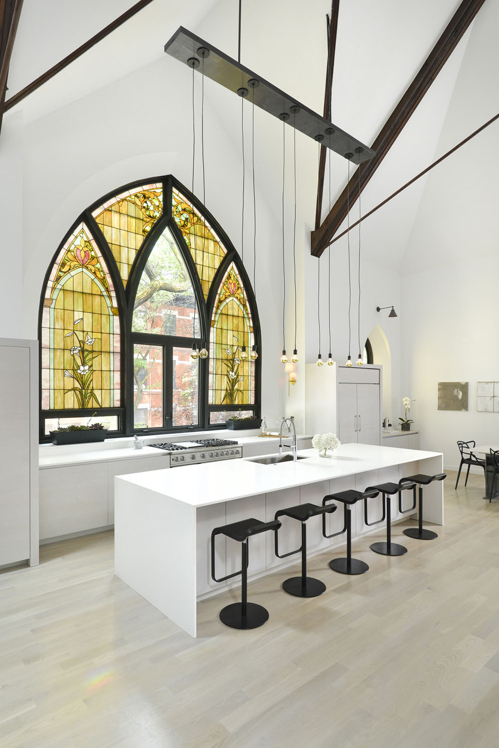White Modern Open Plan Kitchen with Vaulted Ceiling and Stained Glass Window