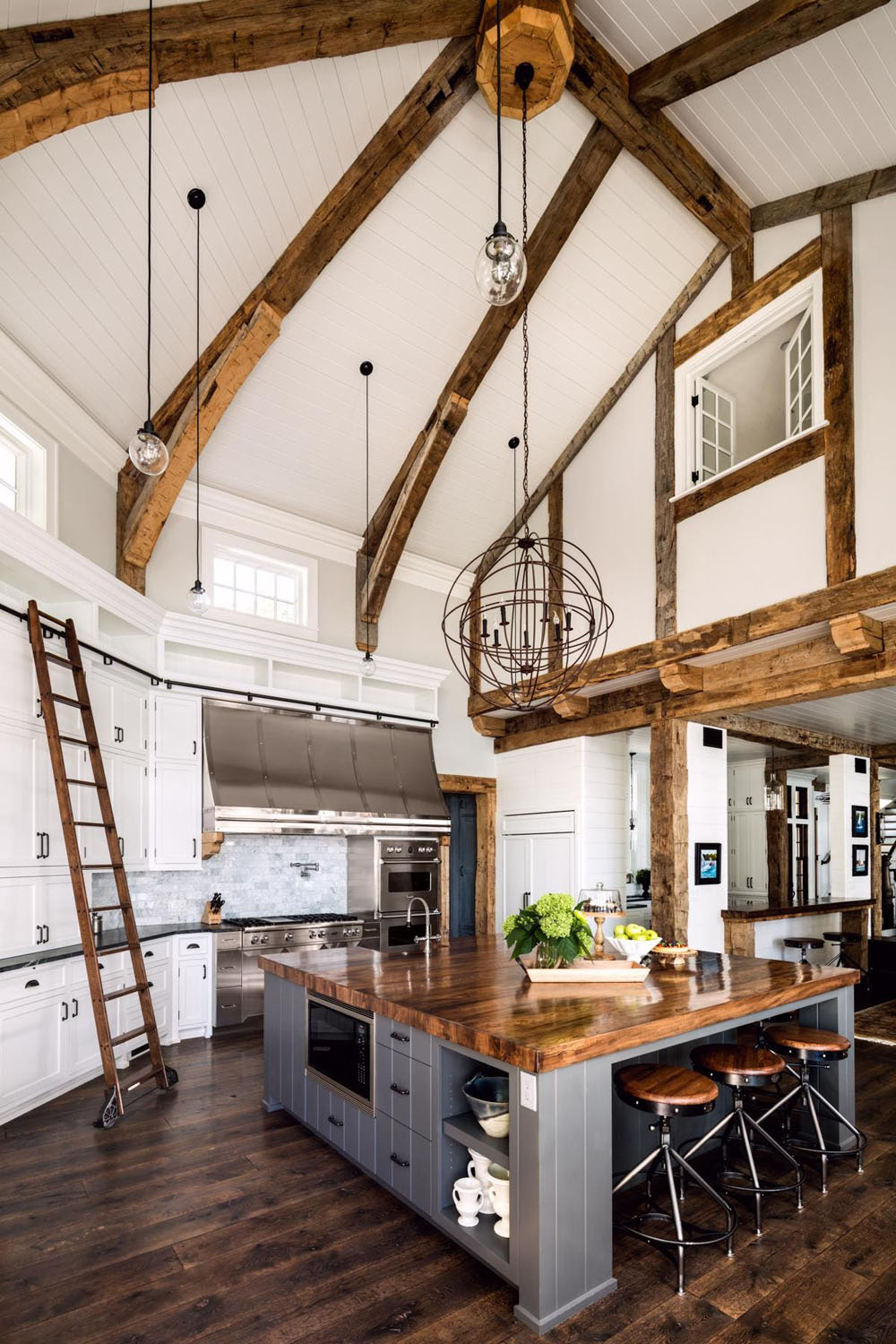 Farmhouse Kitchen with Double-Height Ceiling and Heavy Timber Beams