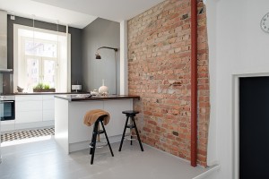 Modern White Kitchen with Rustic Brick Wall