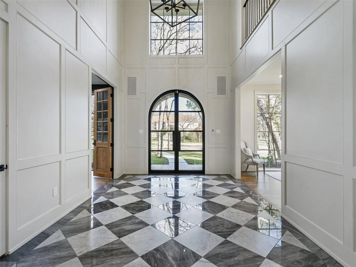 Grand Marble Foyer with Arched Glass and Steel Door