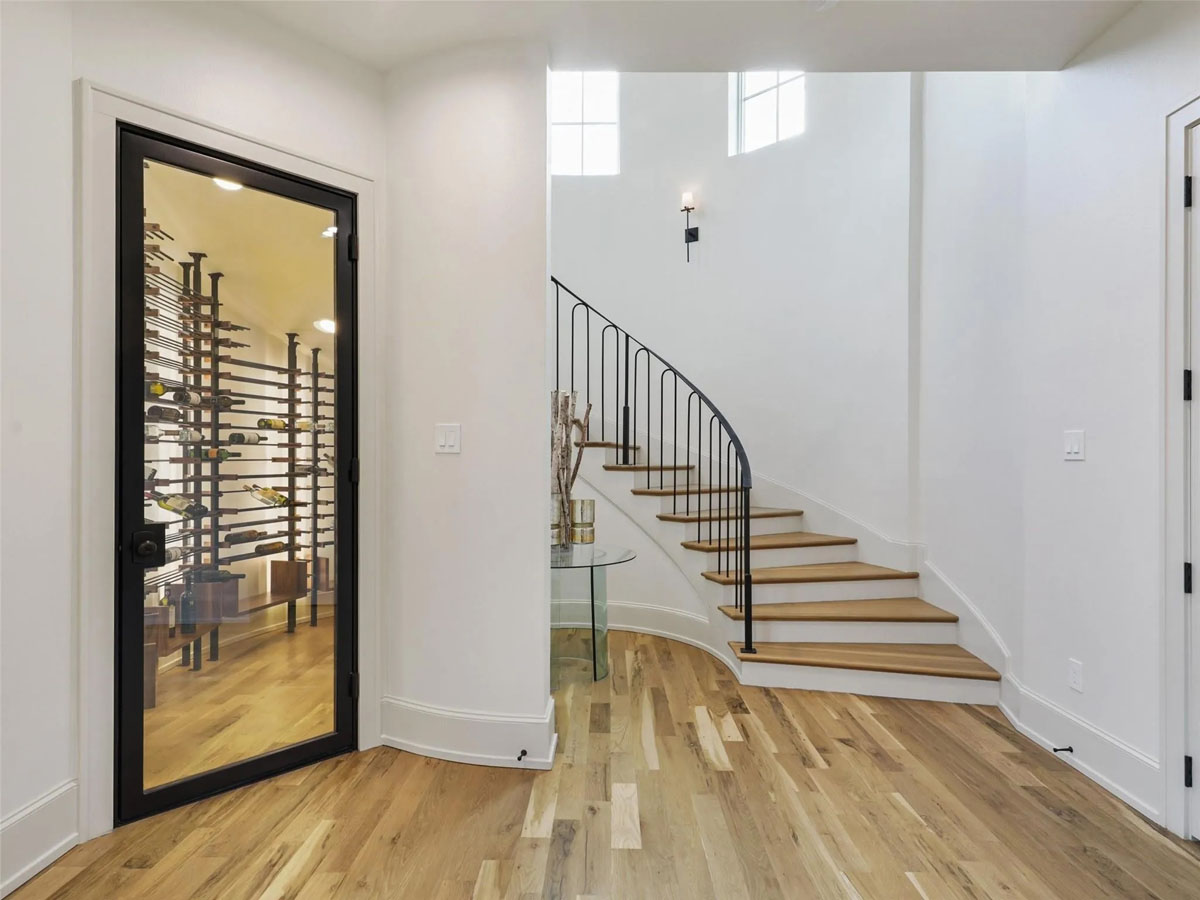 Glass Wine Closet by Curved Staircase
