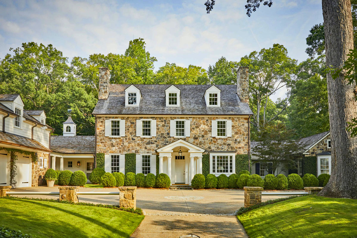 Stone House with White Shutters and Classical Columns