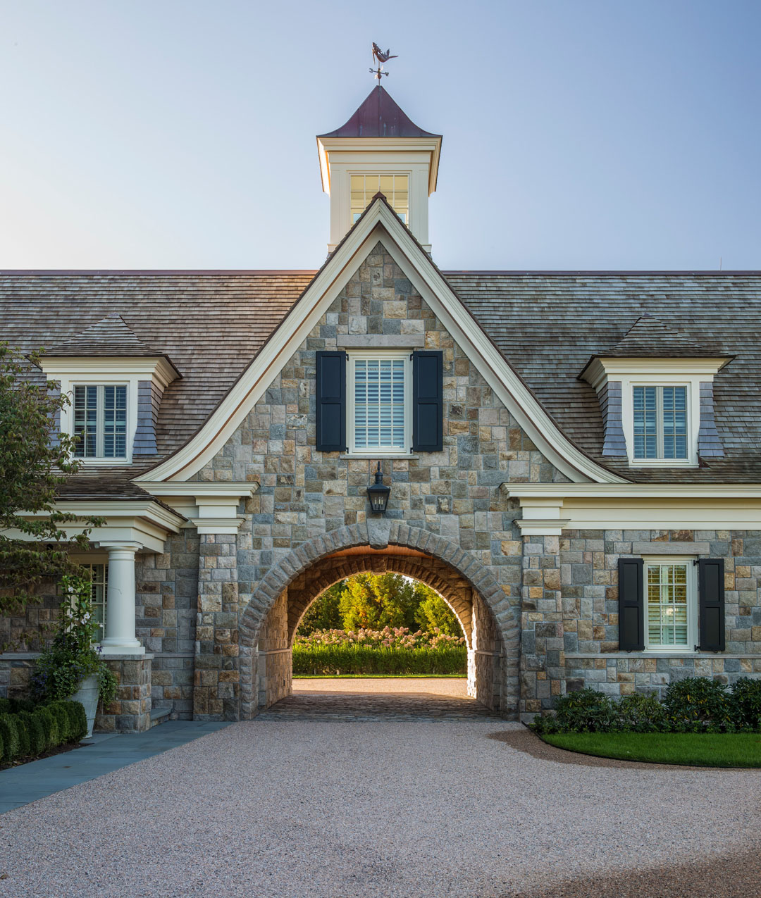 Classic Home with Steeply-Pitched Roof and Fieldstone-Clad Siding