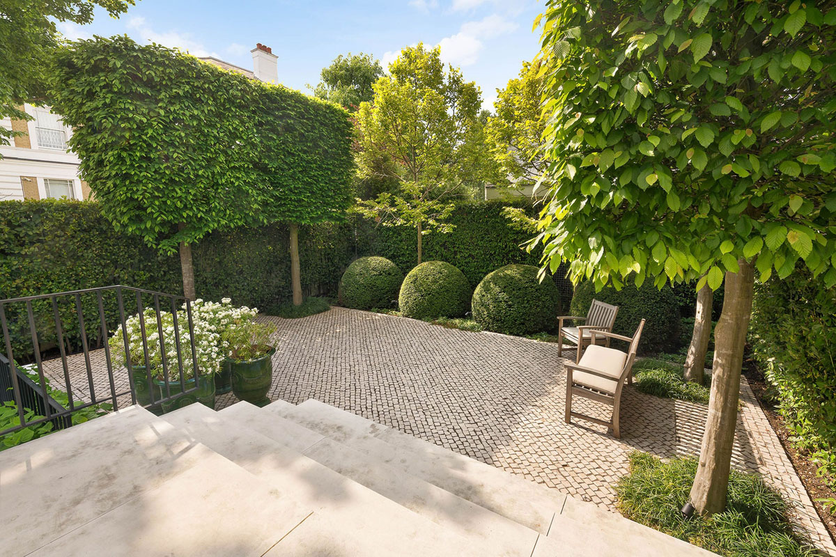 Paved Courtyard Garden with Topiary and Trees