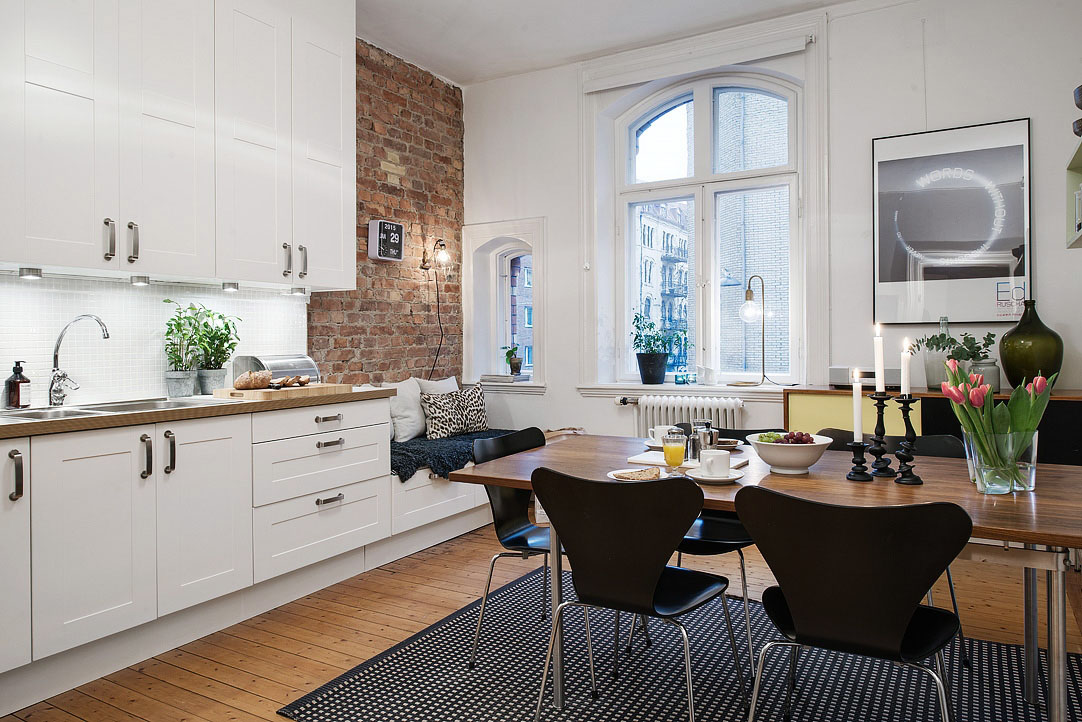 White Modern Kitchen with Rustic Brick Wall