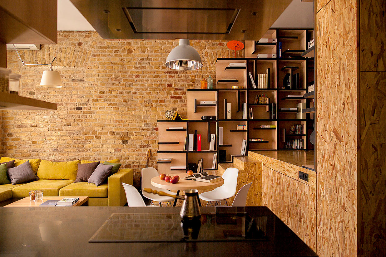 Apartment with Brick Wall and Wood Shelves