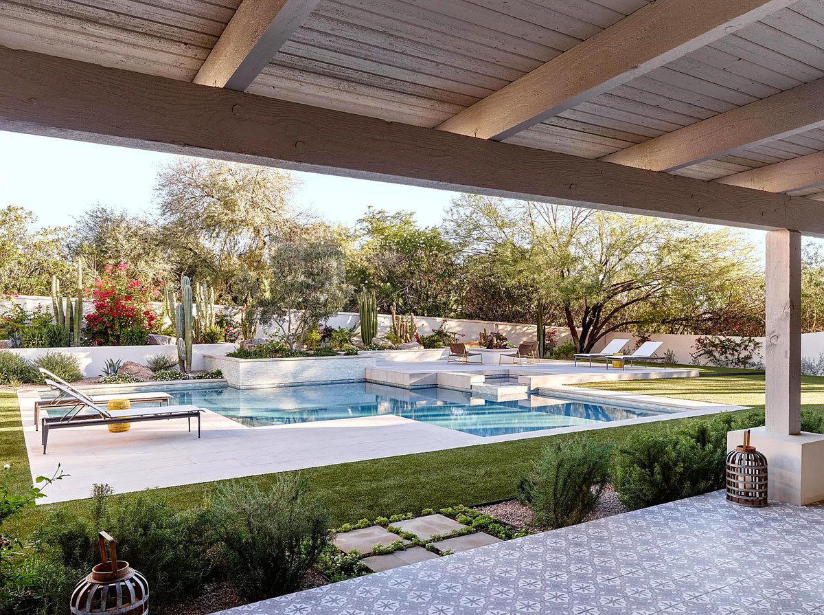 Dreamy Backyard with Limestone Patio and White Glass Tiles by the Pool