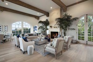 Elegant Living Room with Large Stone Fireplace and Ocean View