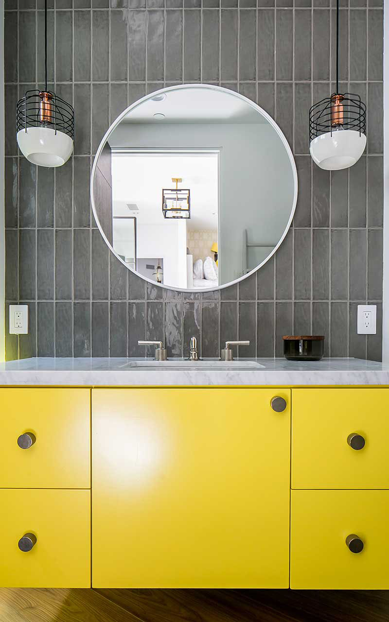 Bathroom with Marble Countertop and Yellow Cabinet