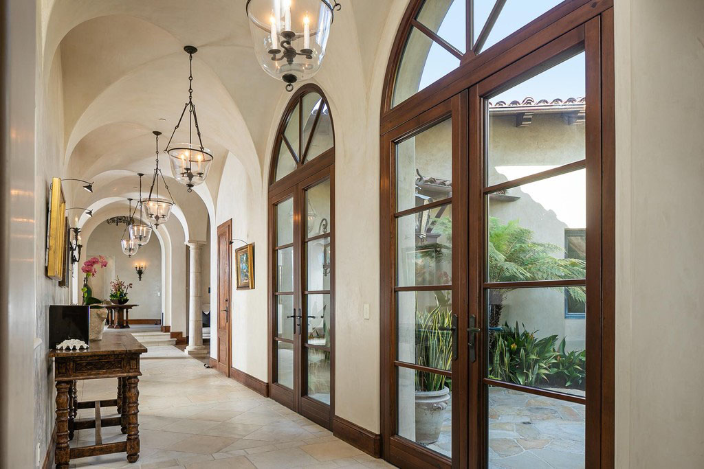 Arched Hallway with Vaulted Ceilings and Arched Doors