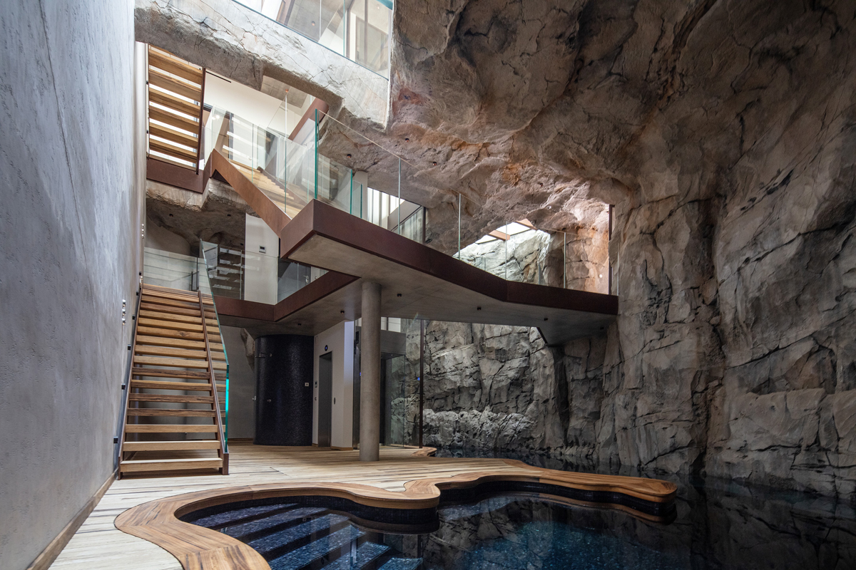 A footbridge from the entrance overlooks the underground swimming pool