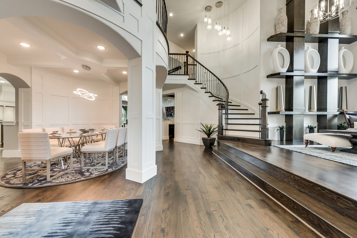 Elegant Staircase with Curved Paneled Walls