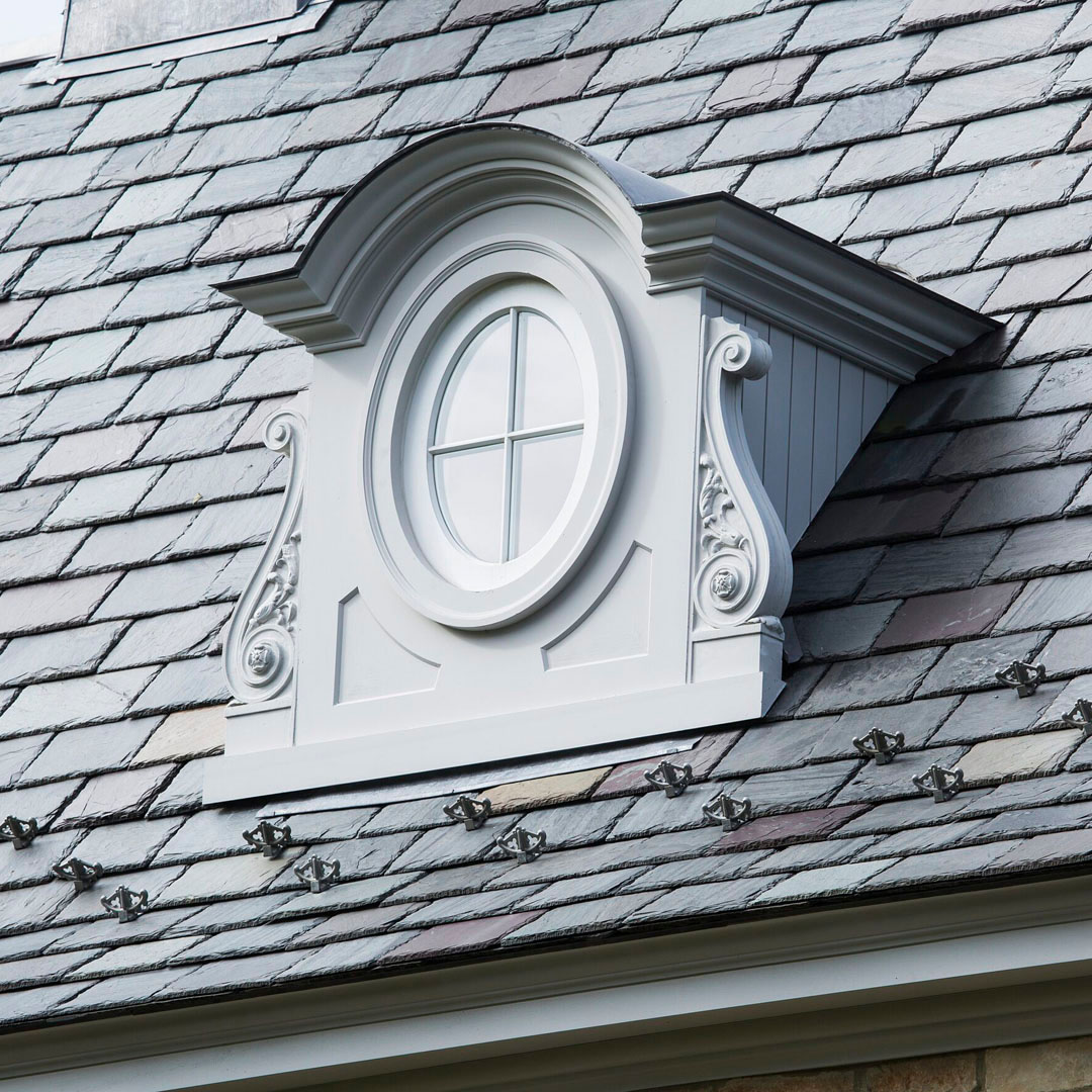 Bull’s-Eye Dormers Framed by Carved Volutes