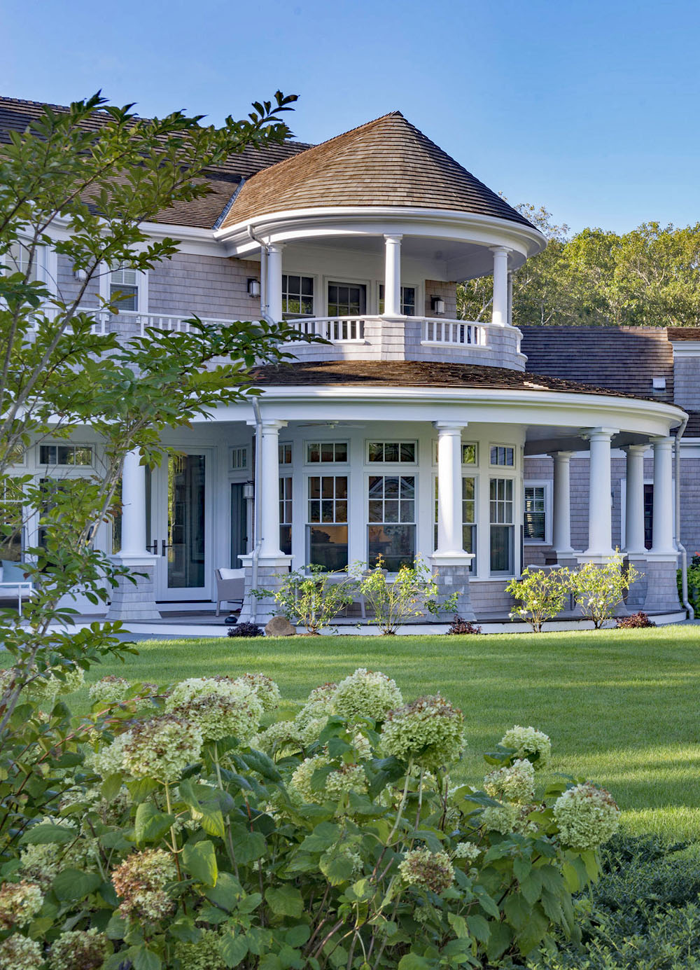 Coastal Shingle Style Cape Cod Home with Large Porch and Classical Columns