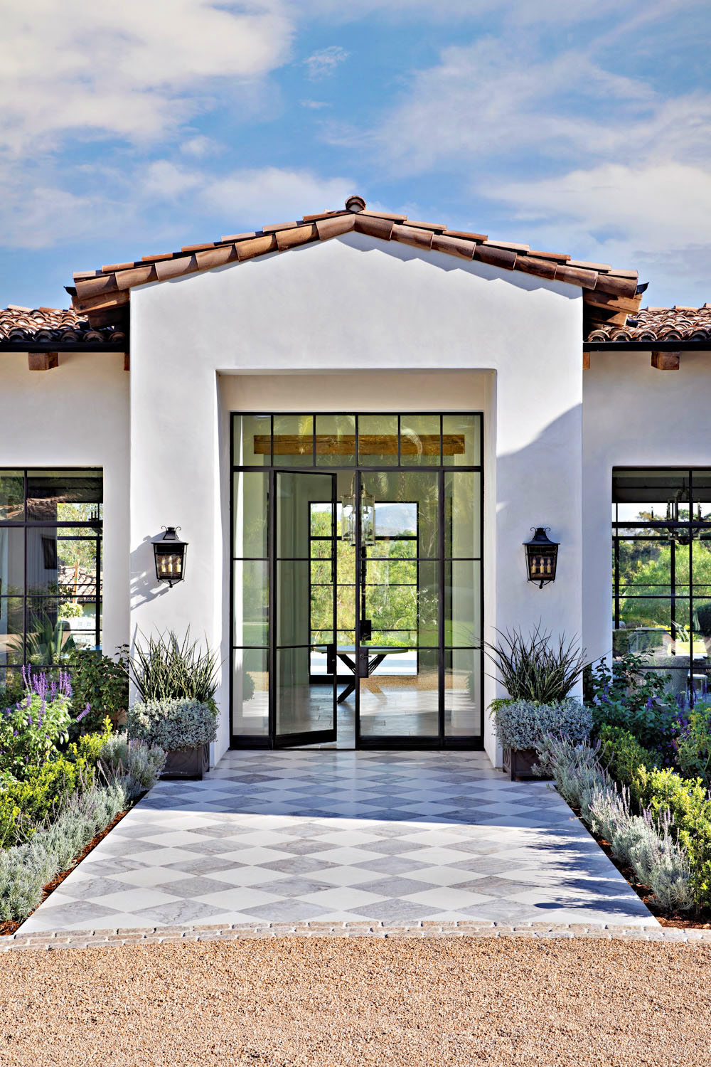 Glass-and-Metal Entry Door with Limestone Tiles in a Checkerboard Pattern