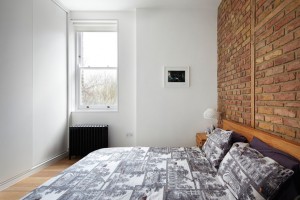 Bedroom with Brick Wall